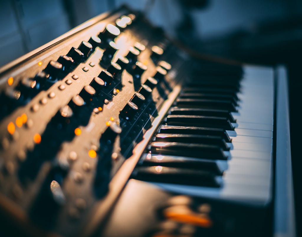 Detailed focus on a piano keyboard and control panel in a music studio setting.